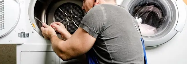 Dryer repair technician fixing a clothes dryer drum in Mobile, AL