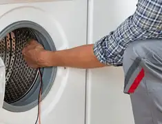 Dryer repair technician diagnosing and servicing a clothes dryer in Mobile, AL