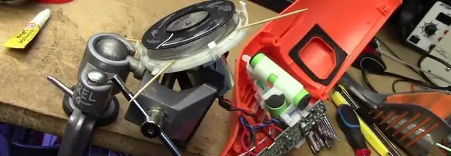 Vacuum cleaner repair parts and tools on a workbench in Mobile, AL