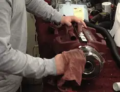 Vacuum repair technician cleaning and servicing a vacuum motor in Mobile, AL
